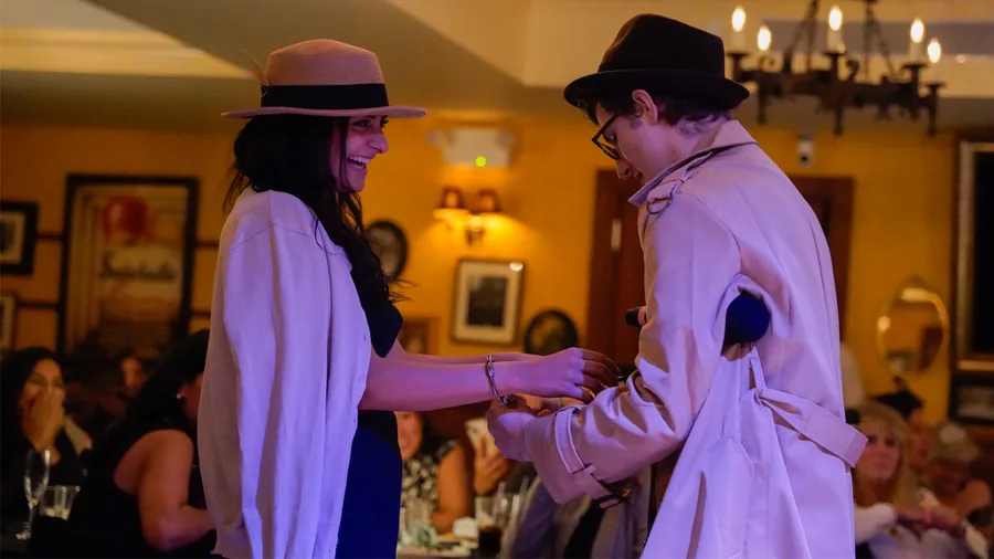 A Murder Mystery Company detective questioning a guest at a Cincinnati show